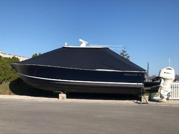 Slide: The Image of 2019 Regulator 34 SS boat with cover on dry dock. - 0