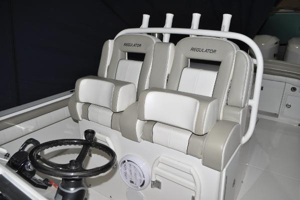 Slide: The Image of 2019 Regulator 34 SS boat cockpit with dual seats and steering wheel. - 15