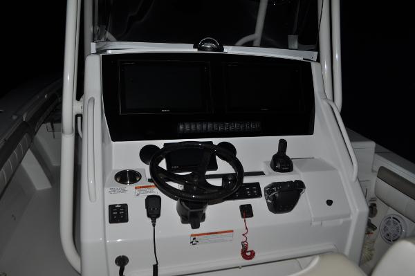 Slide: The Image of 2019 Regulator 34 SS boat dashboard with steering wheel and control panel. - 17