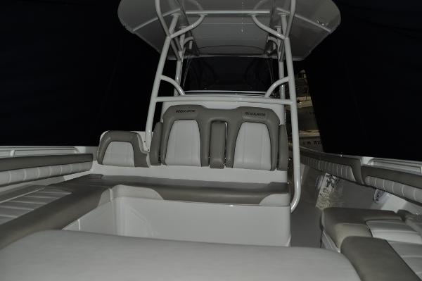 Slide: The Image of 2019 Regulator 34 SS boat interior with cushioned seating and T-top. - 19