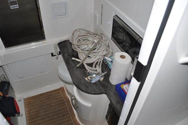 Slide: The Image of 2019 Regulator 34 SS boat interior with storage, rope, and paper towel. - 21