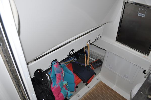 Slide: The Image of Storage compartment in 2019 Regulator 34 SS boat with life jackets and gear. - 22