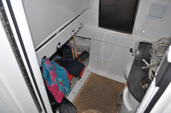 Slide: The Image of 2019 Regulator 34 SS cabin storage area with life jackets and ropes - 23