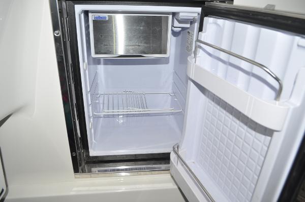 Slide: The Image of Open refrigerator inside a 2019 Regulator 34 SS boat. - 24