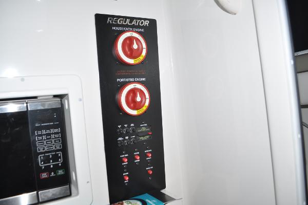Slide: The Image of 2019 Regulator 34 SS control panel with engine switches and microwave. - 27