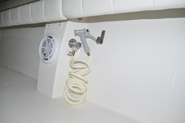 Slide: The Image of 2019 Regulator 34 SS boat interior with coiled hose and speaker. - 28