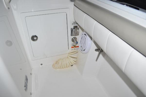 Slide: The Image of 2019 Regulator 34 SS boat interior with storage compartment and coiled hose. - 29