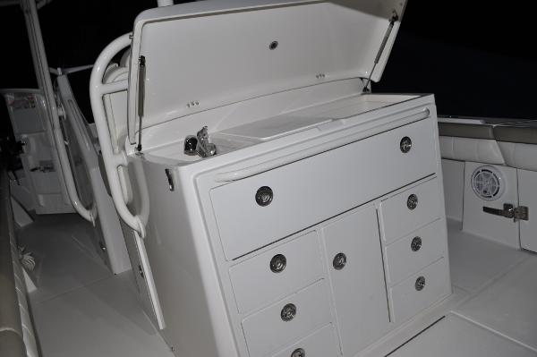 Slide: The Image of 2019 Regulator 34 SS boat interior storage compartments and seating area. - 34