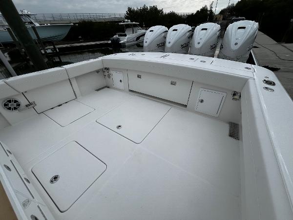 Slide: The Image of 2024 Regulator 41 boat deck with storage compartments and quad outboard engines. - 17