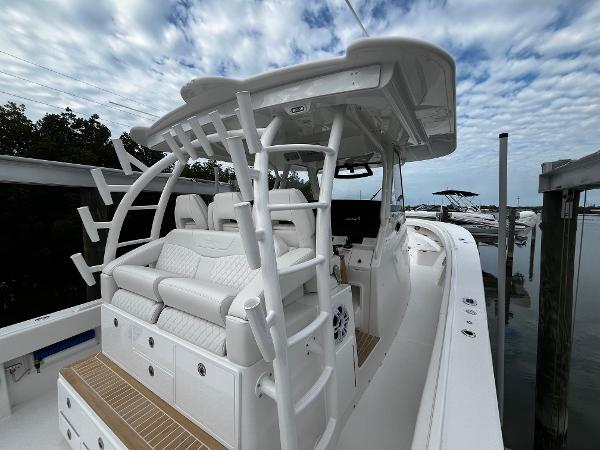 Slide: The Image of 2024 Regulator 41 boat with white seating and sleek design docked by the water. - 22