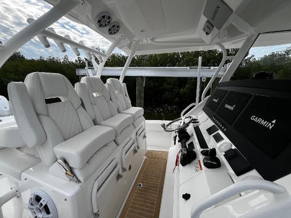 Slide: The Image of 2024 Regulator 41 boat interior with white seating and Garmin navigation system. - 25