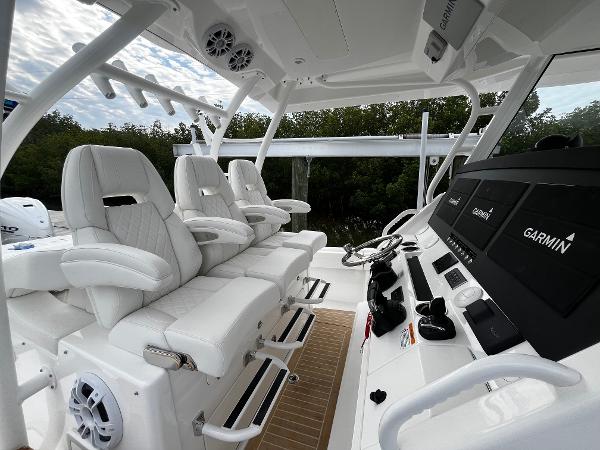 Slide: The Image of 2024 Regulator 41 boat cockpit with white seating and Garmin navigation system. - 26