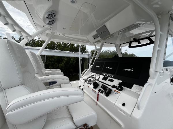 Slide: The Image of 2024 Regulator 41 boat cockpit with white leather seats and Garmin navigation system. - 27