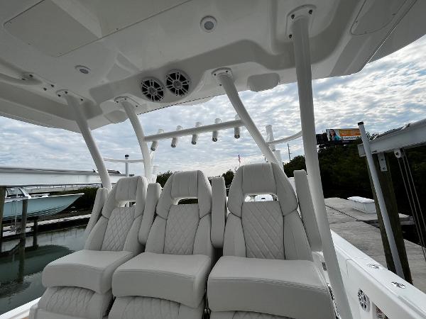 Slide: The Image of 2024 Regulator 41 boat interior with luxurious white seating and overhead speakers. - 28