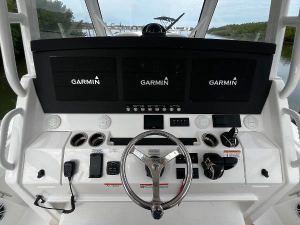Slide: The Image of 2024 Regulator 41 boat helm with Garmin navigation screens and controls. - 29