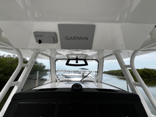 Slide: The Image of 2024 Regulator 41 boat with Garmin navigation system, docked in a serene marina. - 30