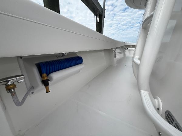 Slide: The Image of 2024 Regulator 41 boat deck with blue hose and white interior. - 33