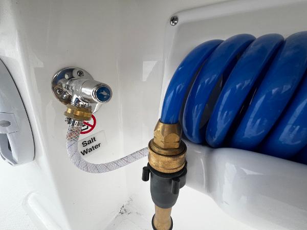 Slide: The Image of 2024 Regulator 41 saltwater hose connection with blue coiled hose. - 34