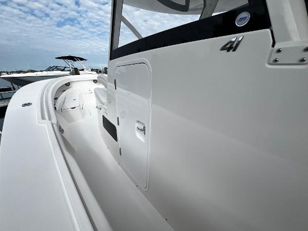 Slide: The Image of 2024 Regulator 41 boat side view with sleek white design. - 35