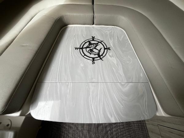 Slide: The Image of 2024 Regulator 41 boat interior with compass design on table. - 38