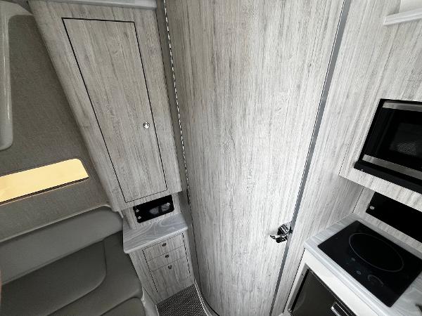 Slide: The Image of 2024 Regulator 41 interior cabin with modern kitchen and storage. - 40