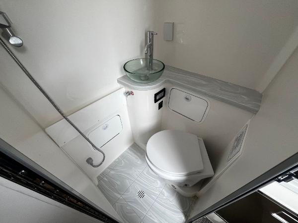Slide: The Image of 2024 Regulator 41 boat bathroom with modern fixtures and glass sink. - 41