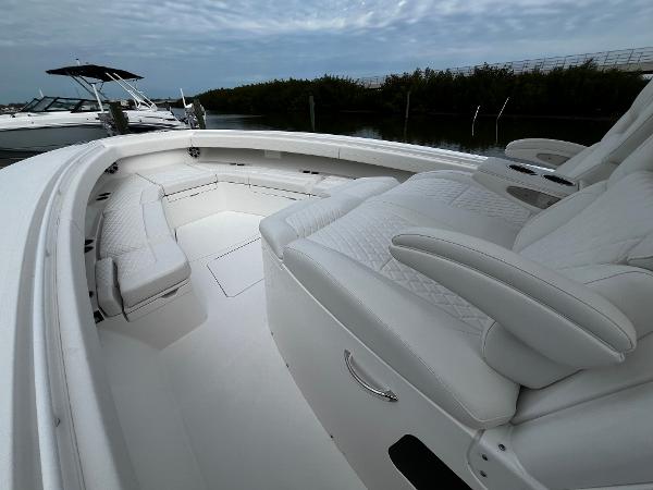 Slide: The Image of 2024 Regulator 41 boat with luxurious white seating and spacious deck. - 44