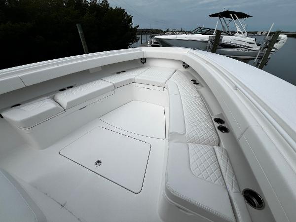 Slide: The Image of 2024 Regulator 41 boat with spacious white seating area and sleek design. - 45