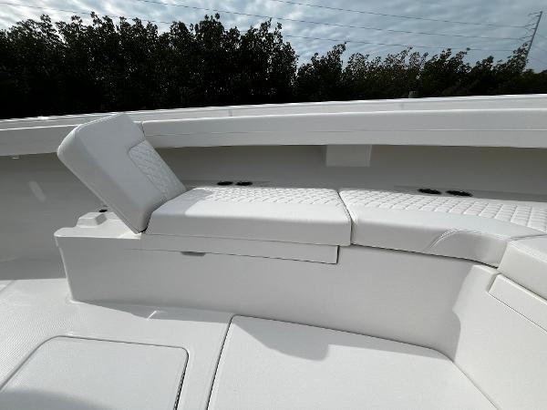 Slide: The Image of 2024 Regulator 41 boat with white cushioned seating area. - 46