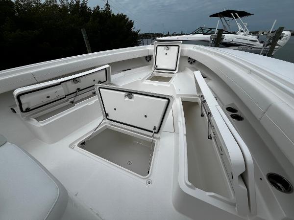 Slide: The Image of 2024 Regulator 41 boat with open storage compartments on deck. - 49