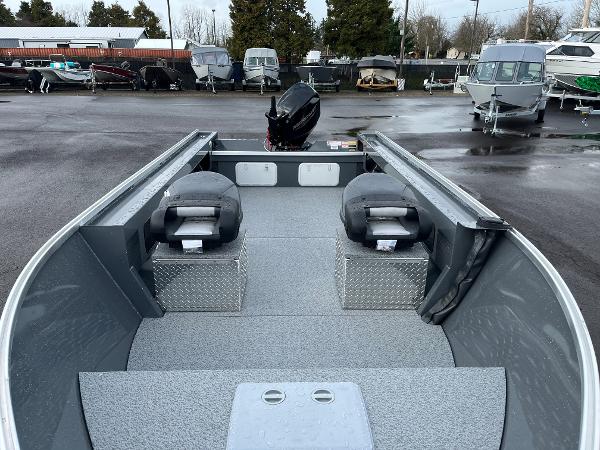 Slide: The Image of 2024 RH Boats Pro V 18 fishing boat interior with dual seats and outboard motor. - 2