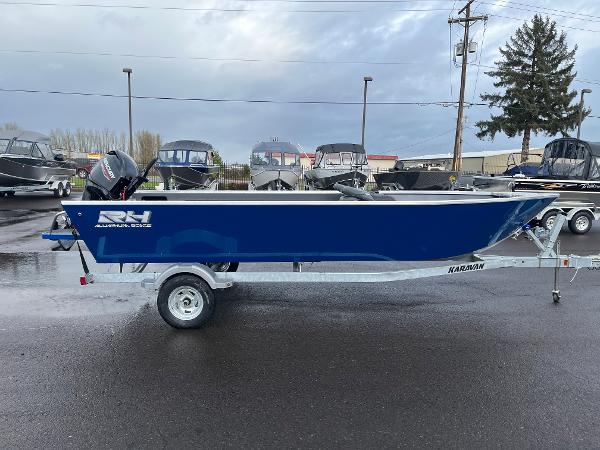 Slide: The Image of 2024 RH Boats Pro V 18 on trailer, blue hull, parked in a lot. - 5