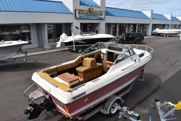 Slide: The Image of 1983 Rinker 204 Cuddy Cabin boat on trailer at dealership. - 0