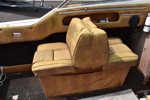 Slide: The Image of Vintage 1983 Rinker 204 Cuddy Cabin boat interior with tan seating. - 7