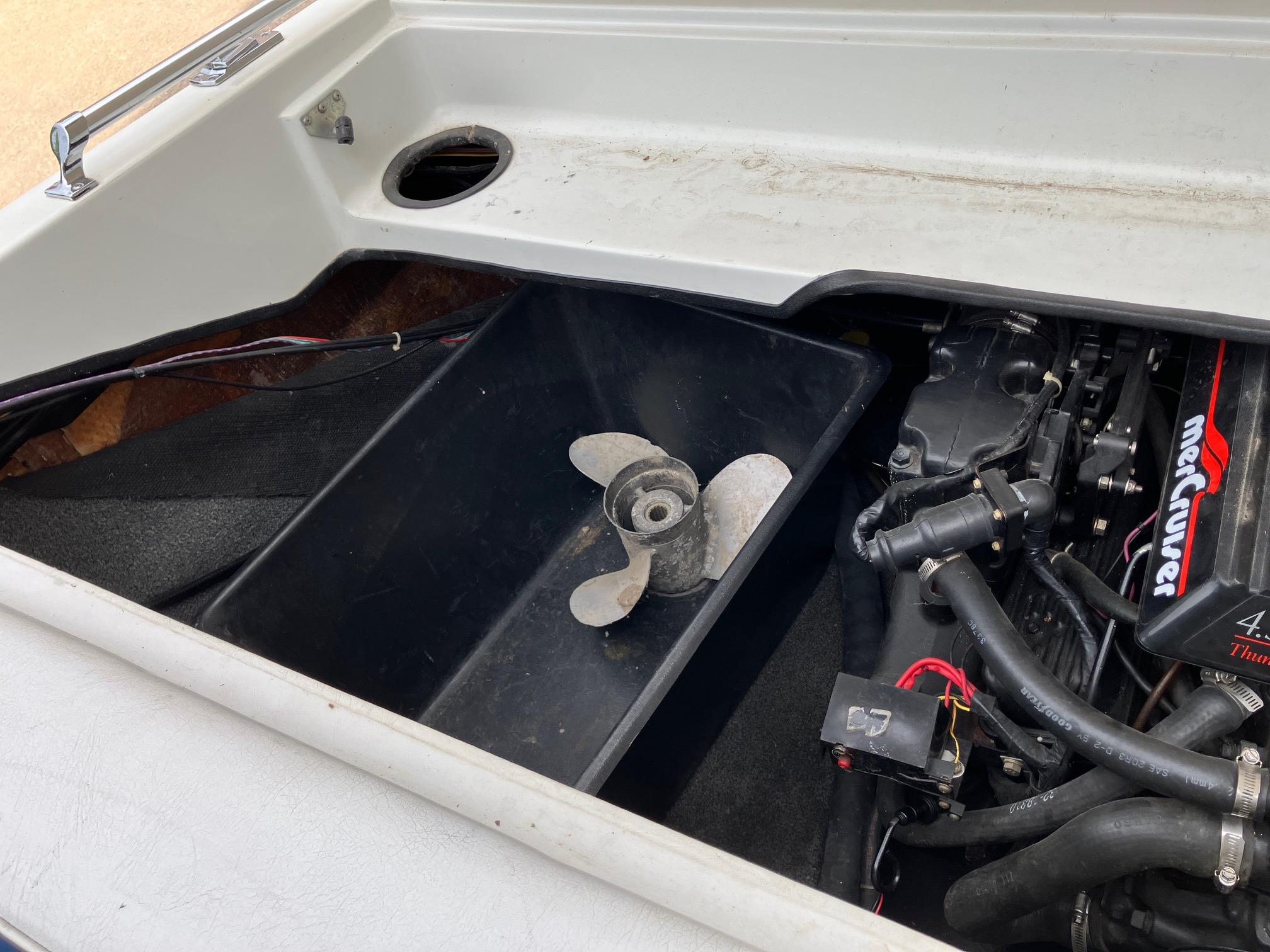 Slide: The Image of 1989 Rinker 206 Open Bow boat engine compartment with propeller and MerCruiser components. - 10