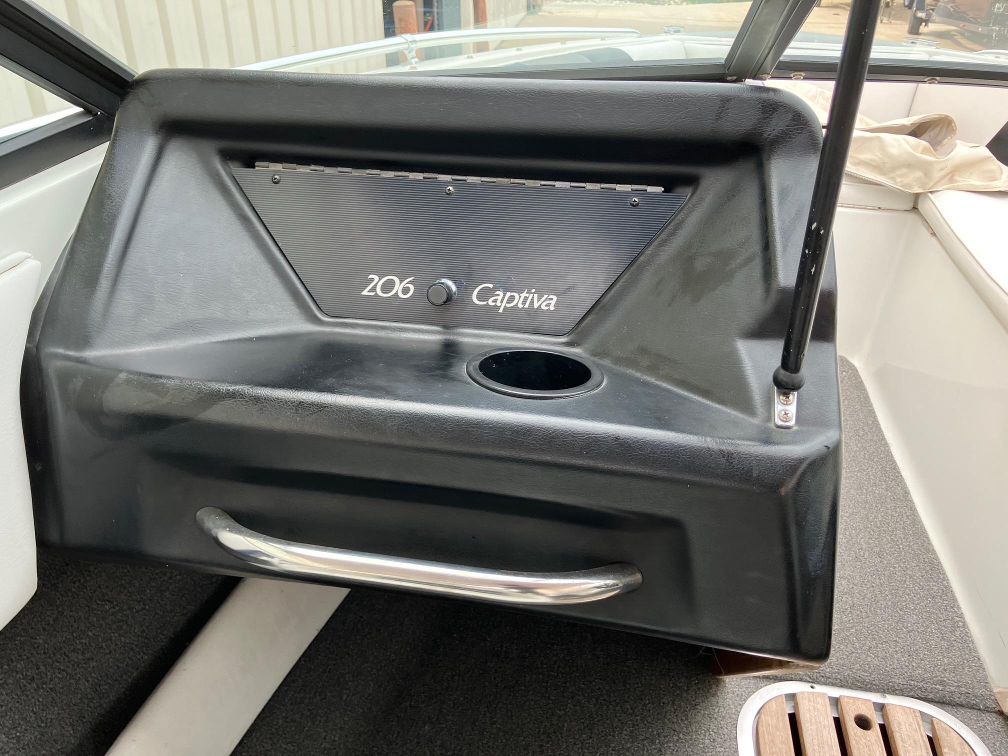 Slide: The Image of 1989 Rinker 206 Open Bow Captiva boat interior with cup holder and handle. - 14