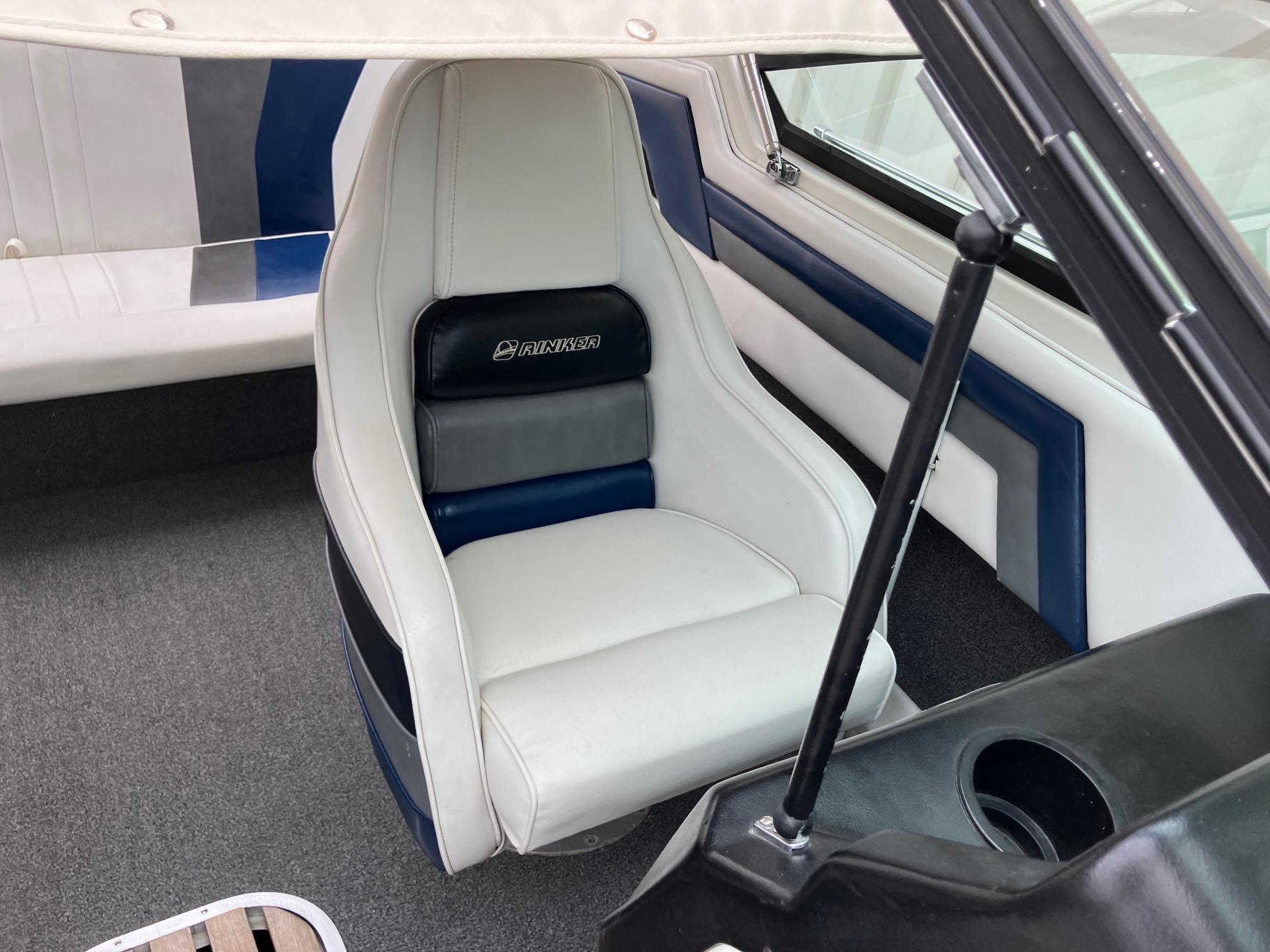 Slide: The Image of 1989 Rinker 206 Open Bow boat interior with white and blue seating. - 19