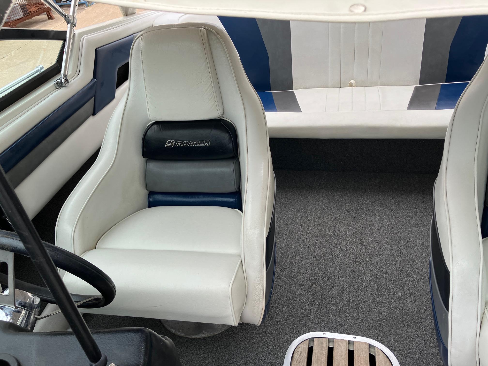 Slide: The Image of 1989 Rinker 206 Open Bow boat interior with white and blue seating. - 20