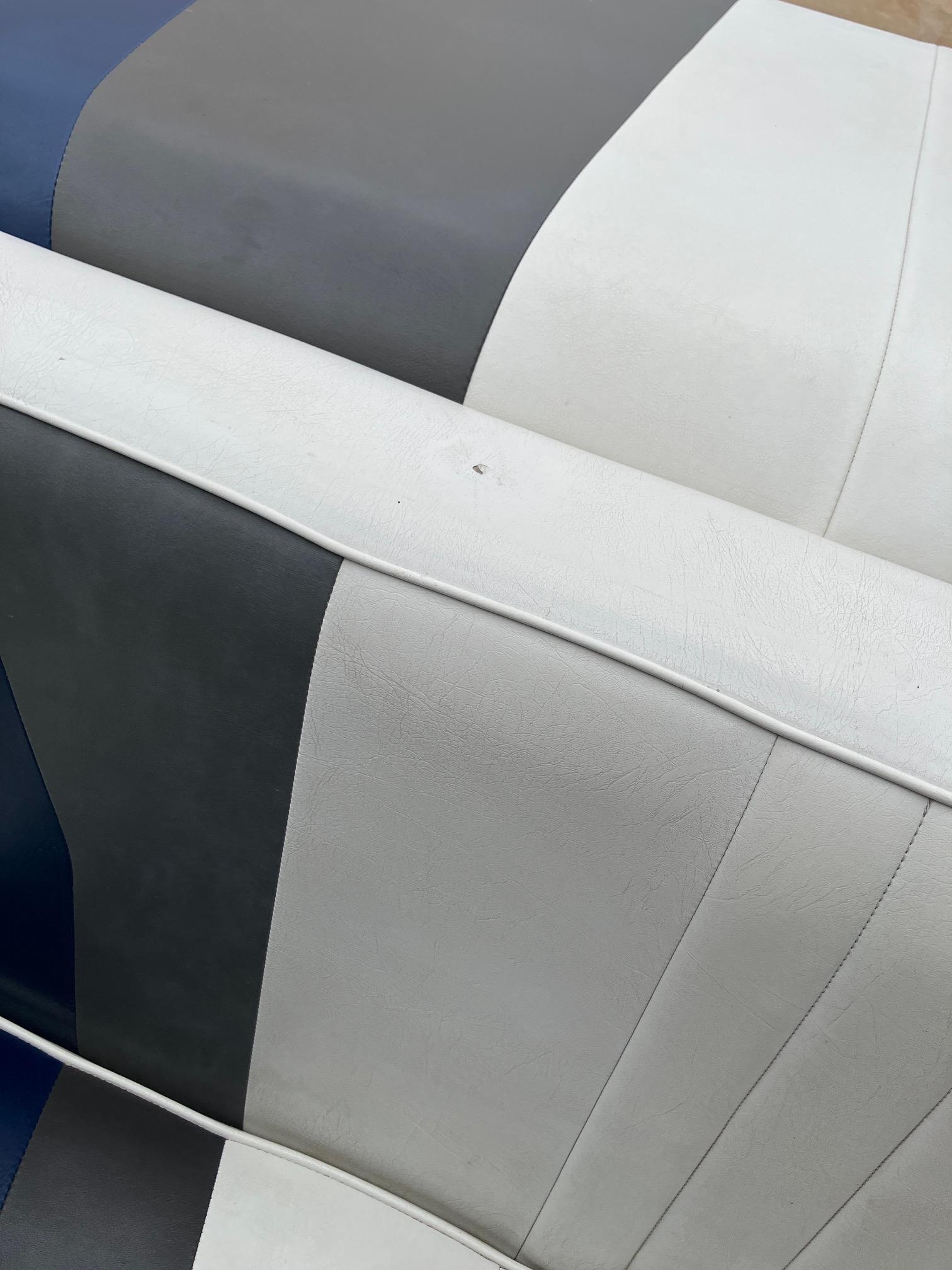 Slide: The Image of Striped upholstery on 1989 Rinker 206 Open Bow boat seat, featuring gray, white, and blue colors. - 21