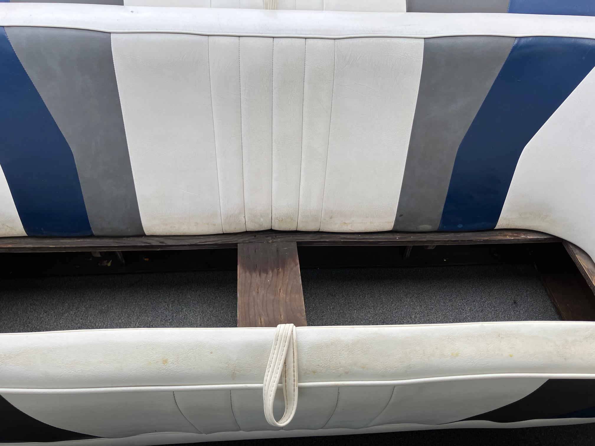 Slide: The Image of 1989 Rinker 206 Open Bow boat interior with blue, gray, and white seating. - 8