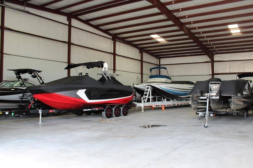 Slide: The Image of Boats stored in a spacious indoor facility, featuring a 1994 Rinker 209 Captiva. - 10