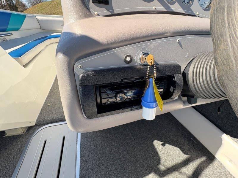 Slide: The Image of Dashboard of a 1994 Rinker 209 Captiva boat with ignition key and stereo system. - 13