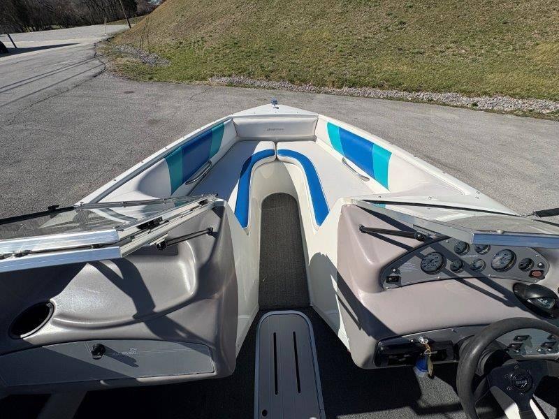 Slide: The Image of 1994 Rinker 209 Captiva boat interior with blue and white seating, dashboard, and steering wheel. - 15
