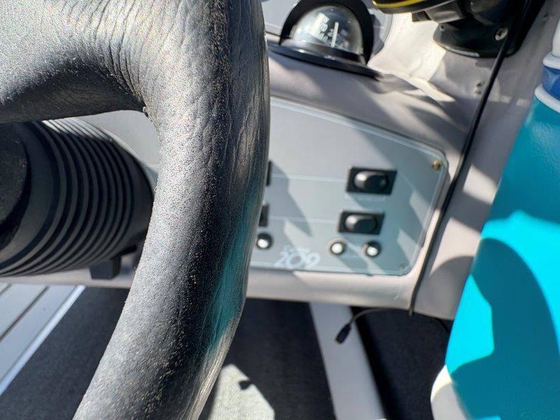 Slide: The Image of Close-up of 1994 Rinker 209 Captiva boat dashboard and steering wheel. - 16