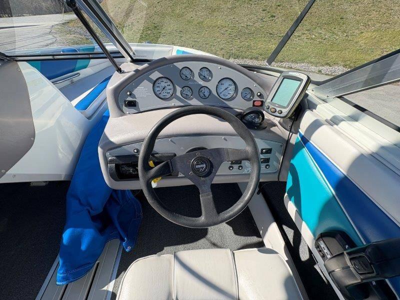 Slide: The Image of 1994 Rinker 209 Captiva boat dashboard with steering wheel and gauges. - 17