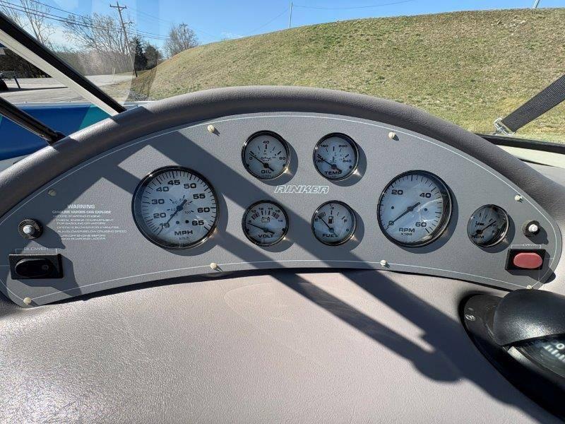 Slide: The Image of Dashboard of a 1994 Rinker 209 Captiva boat with gauges and controls. - 18