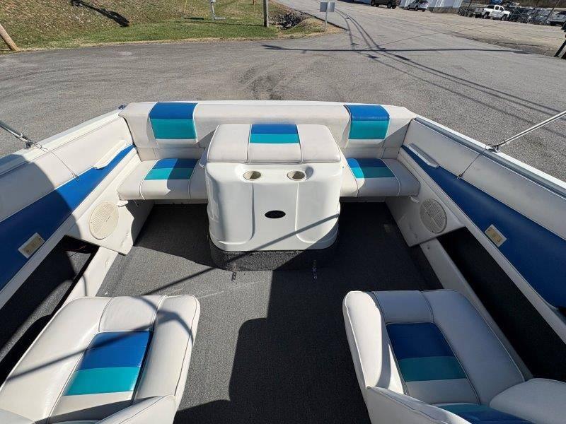 Slide: The Image of 1994 Rinker 209 Captiva boat interior with blue and white seating and cup holders. - 19