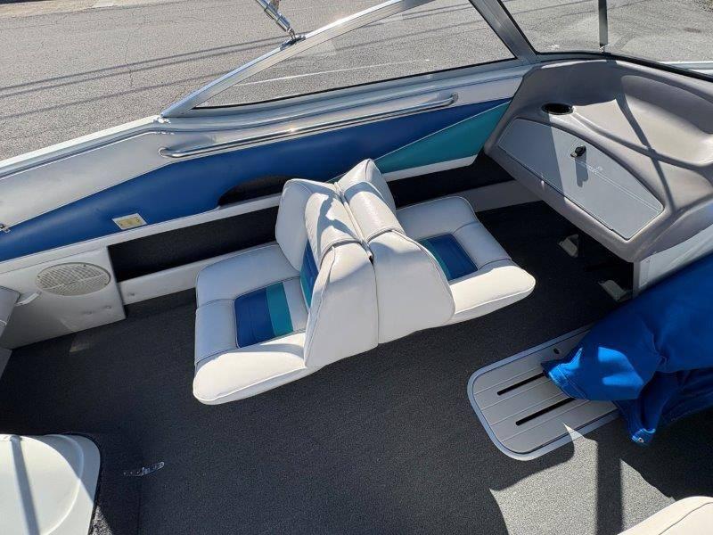 Slide: The Image of 1994 Rinker 209 Captiva boat interior with blue and white seating. - 20