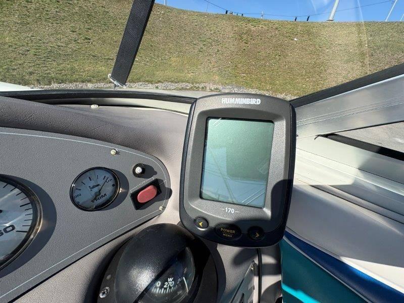Slide: The Image of Dashboard of a 1994 Rinker 209 Captiva boat with Humminbird fish finder. - 27
