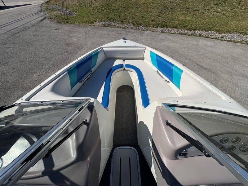 Slide: The Image of 1994 Rinker 209 Captiva boat interior with blue and white seating, open bow design. - 28